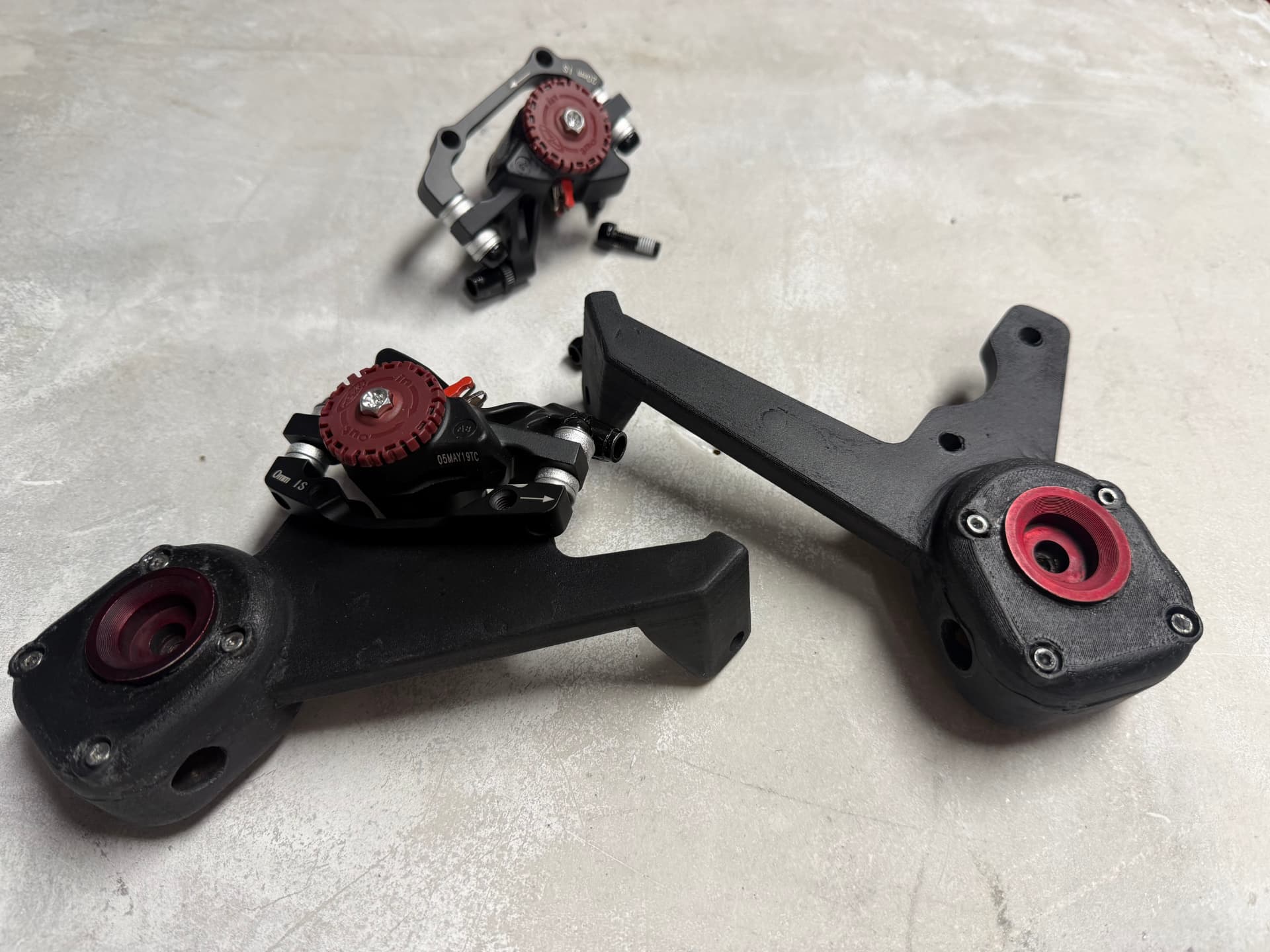 Suspension arms with brake mounts